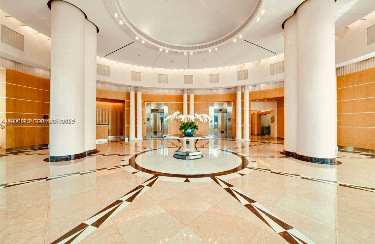 2127 Brickell Avenue, Unit 1505 Miami, FL 33129 - Photo 27 of 37 a dining room with large window a table and chairs