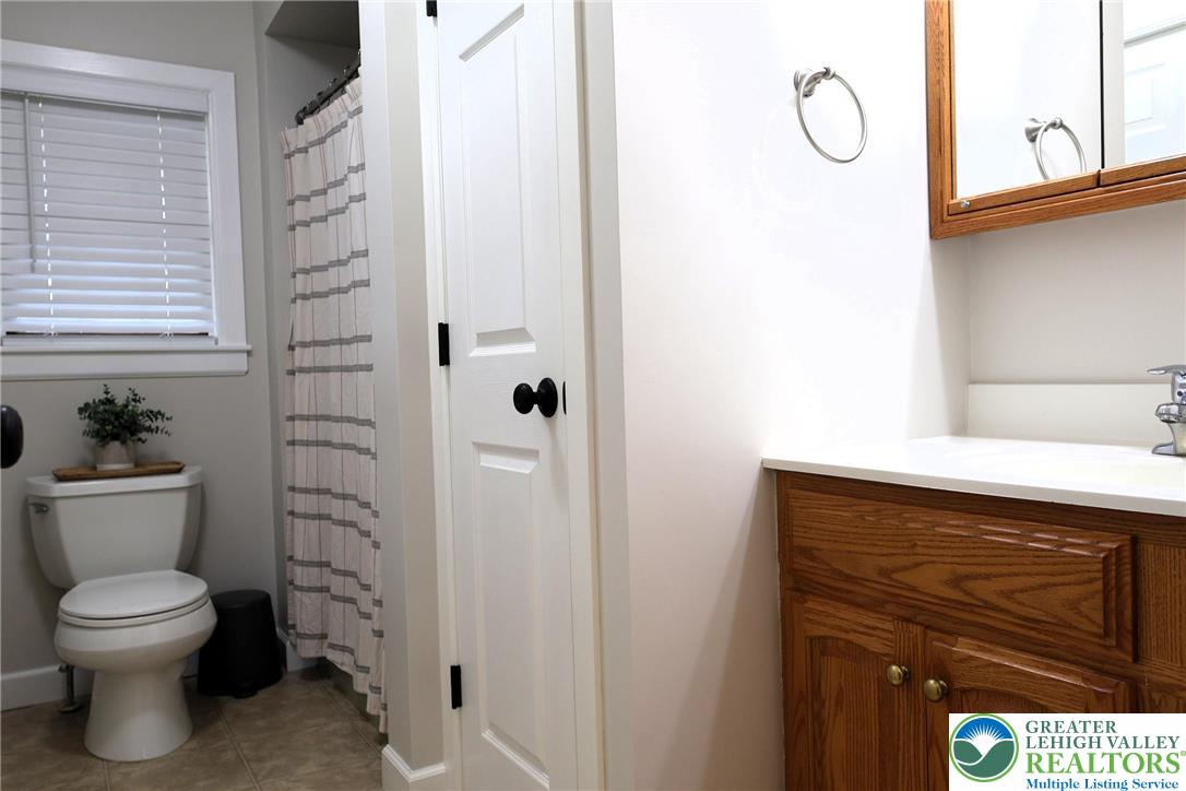 8297 Mertztown Road Lower Macungie Township, PA 18011 - Photo 11 of 22 a bathroom with a toilet a sink and a shower