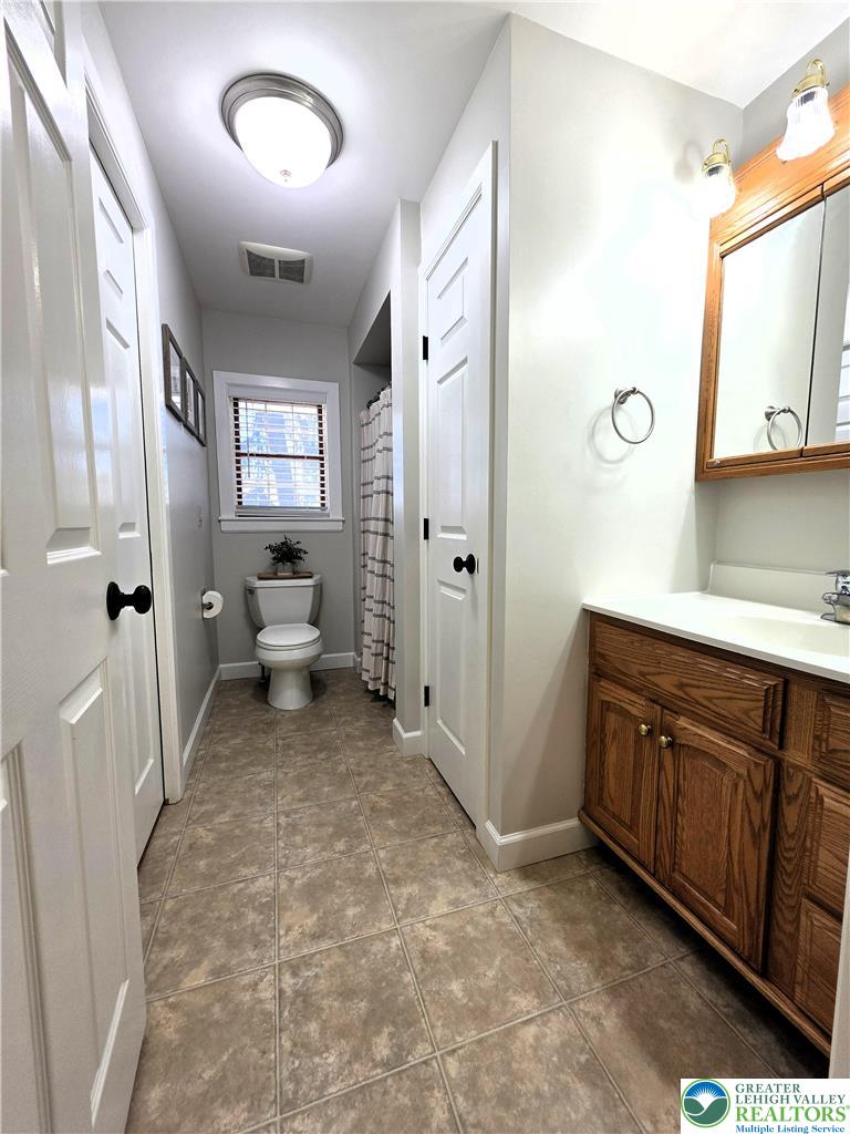 8297 Mertztown Road Lower Macungie Township, PA 18011 - Photo 12 of 22 a spacious bathroom with a sink and a mirror