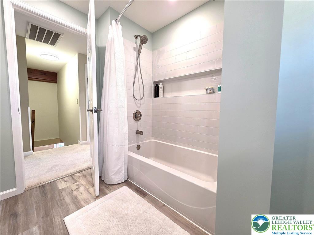 8297 Mertztown Road Lower Macungie Township, PA 18011 - Photo 20 of 22 a bathroom with a bathtub and a shower