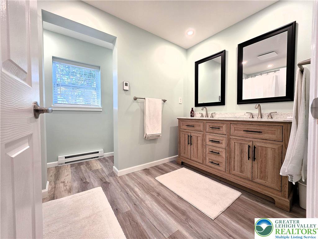 8297 Mertztown Road Lower Macungie Township, PA 18011 - Photo 21 of 22 a bathroom with a sink a mirror and a bathtub