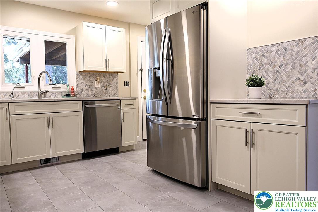 8297 Mertztown Road Lower Macungie Township, PA 18011 - Photo 7 of 22 a kitchen with stainless steel appliances granite countertop a refrigerator sink and cabinets