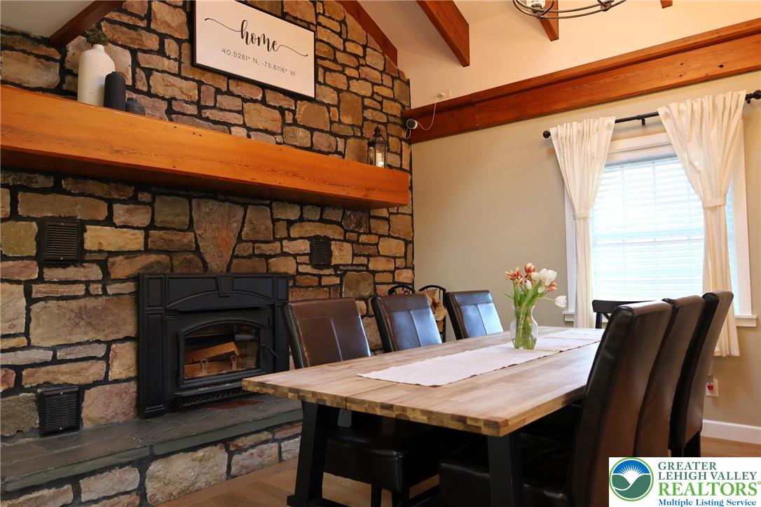 8297 Mertztown Road Lower Macungie Township, PA 18011 - Photo 8 of 22 a dining table with chairs and a fireplace