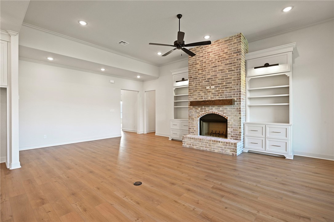 7052 Skipping Rock Path Bryan, TX 77808 - Photo 4 of 23 a view of an empty room with wooden floor fireplace and a window