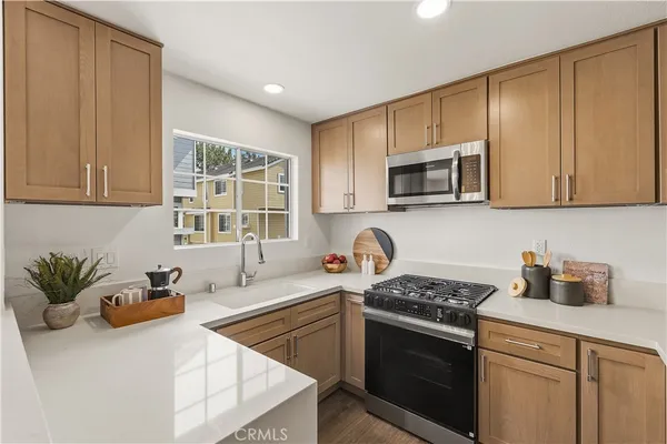 a kitchen with stainless steel appliances granite countertop a sink stove and microwave