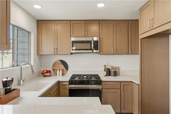 a kitchen with a stove a sink and a microwave