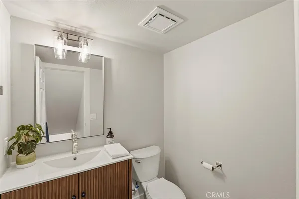 a bathroom with a sink a toilet and mirror