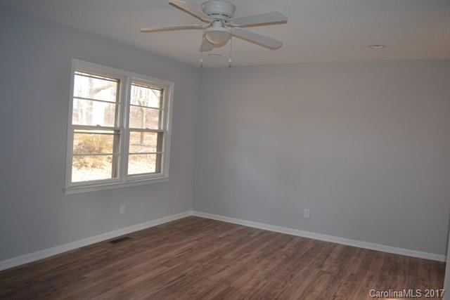 2665 Center Road Chester, SC 29706 - Photo 3 of 12 an empty room with wooden floor fan and windows