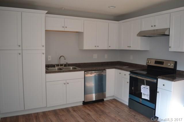 2665 Center Road Chester, SC 29706 - Photo 4 of 12 a kitchen with granite countertop a stove and a white cabinets