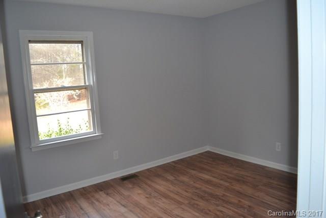 2665 Center Road Chester, SC 29706 - Photo 5 of 12 an empty room with wooden floor and windows