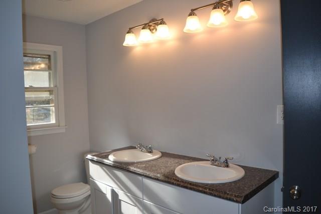 2665 Center Road Chester, SC 29706 - Photo 8 of 12 a bathroom with a granite countertop sink and a toilet