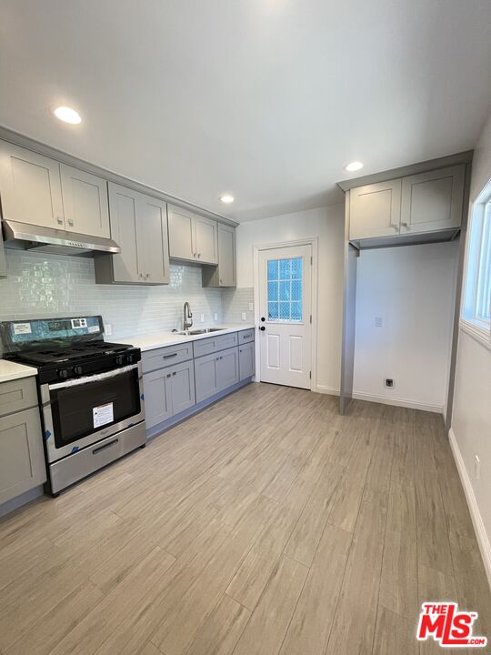 280 Grandview Street Pasadena, CA 91104 - Photo 8 of 34 a kitchen with stainless steel appliances a refrigerator sink and cabinets