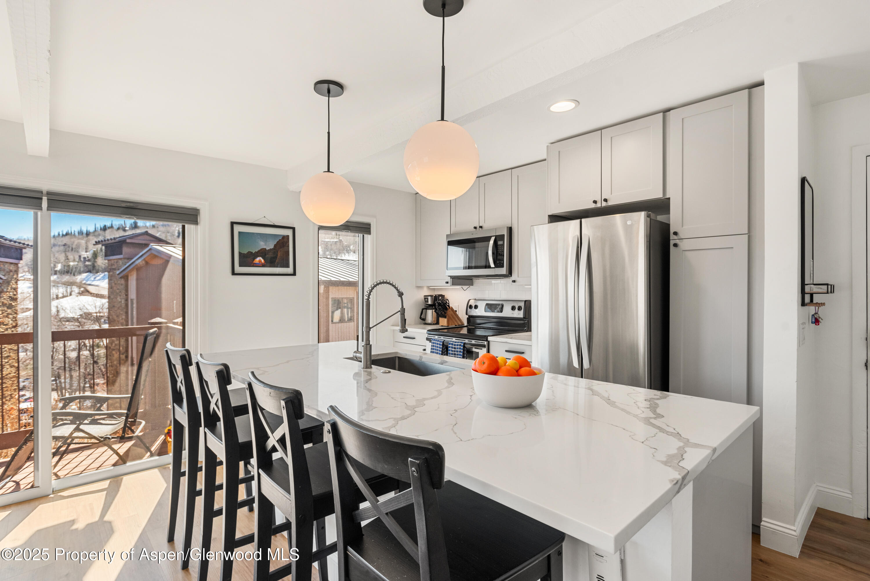 35 Upper Woodbridge Road, Unit 34CD Snowmass Village, CO 81615 - Photo 3 of 22 a view of a dining room with furniture window and wooden floor