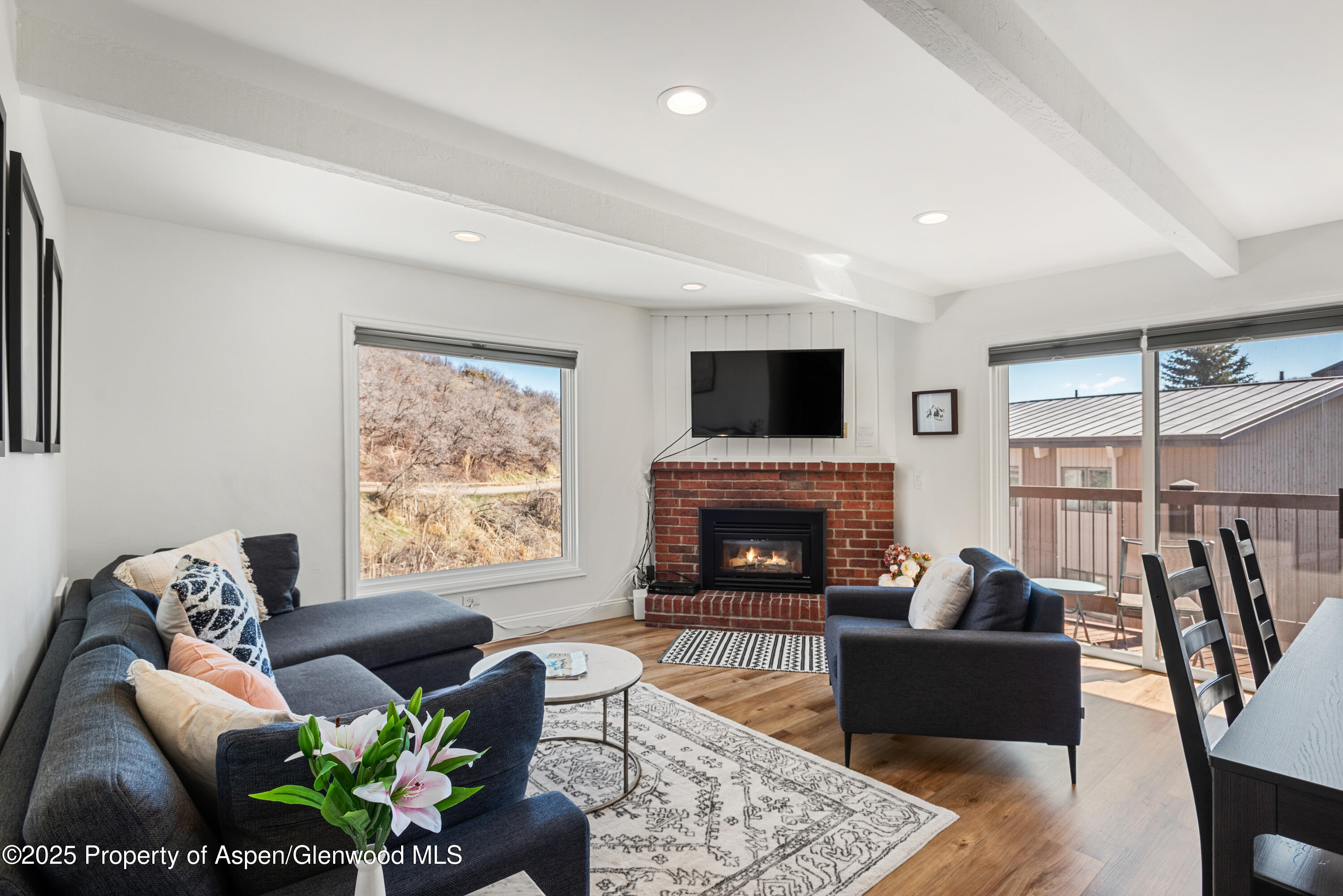 35 Upper Woodbridge Road, Unit 34CD Snowmass Village, CO 81615 - Photo 7 of 22 a living room with furniture fireplace and a large window
