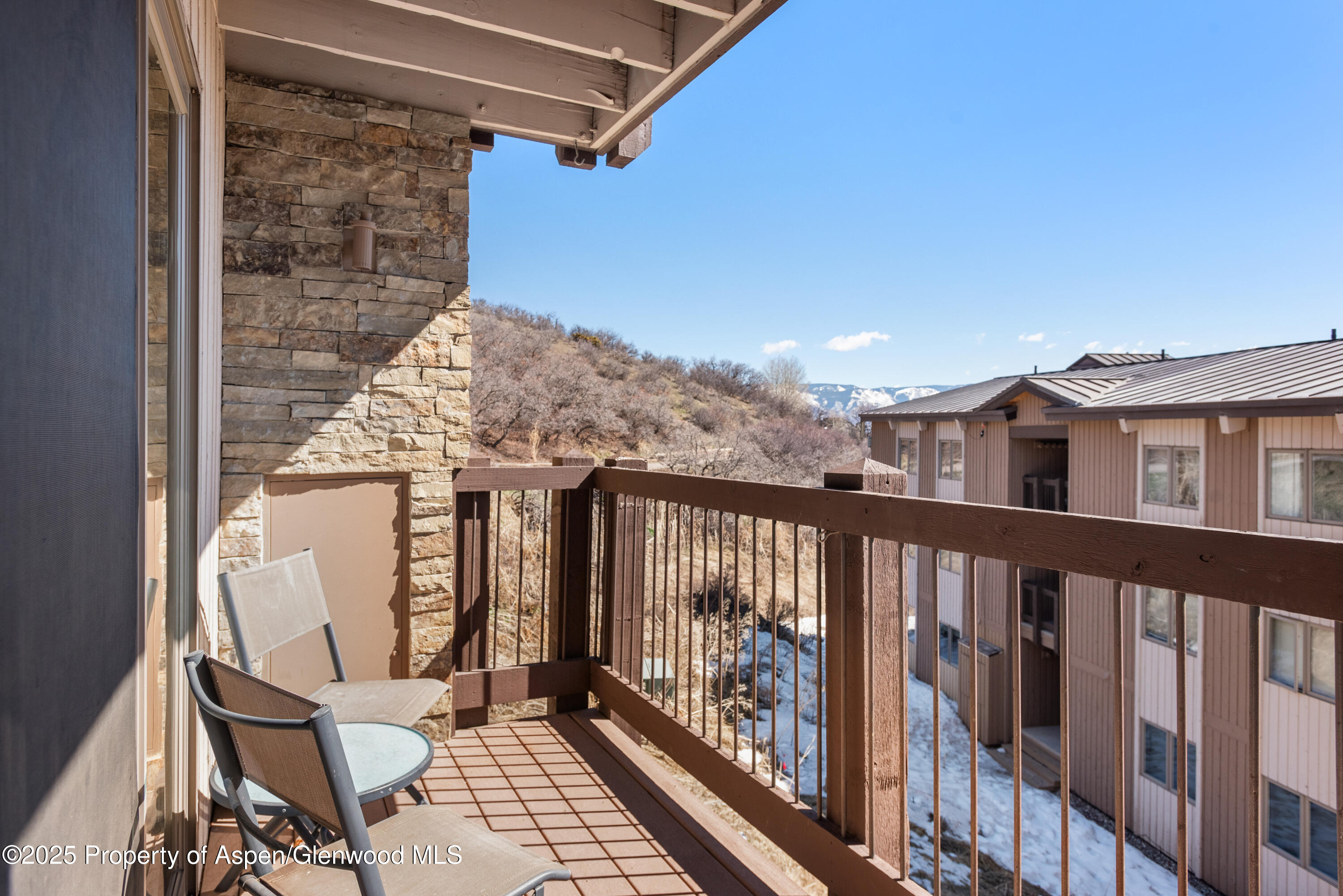 35 Upper Woodbridge Road, Unit 34CD Snowmass Village, CO 81615 - Photo 8 of 22 a view of a balcony with chair