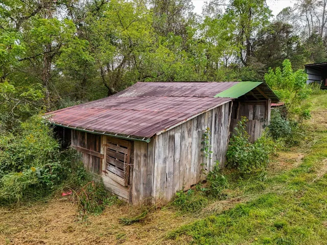 a view of a house with a garden and plants