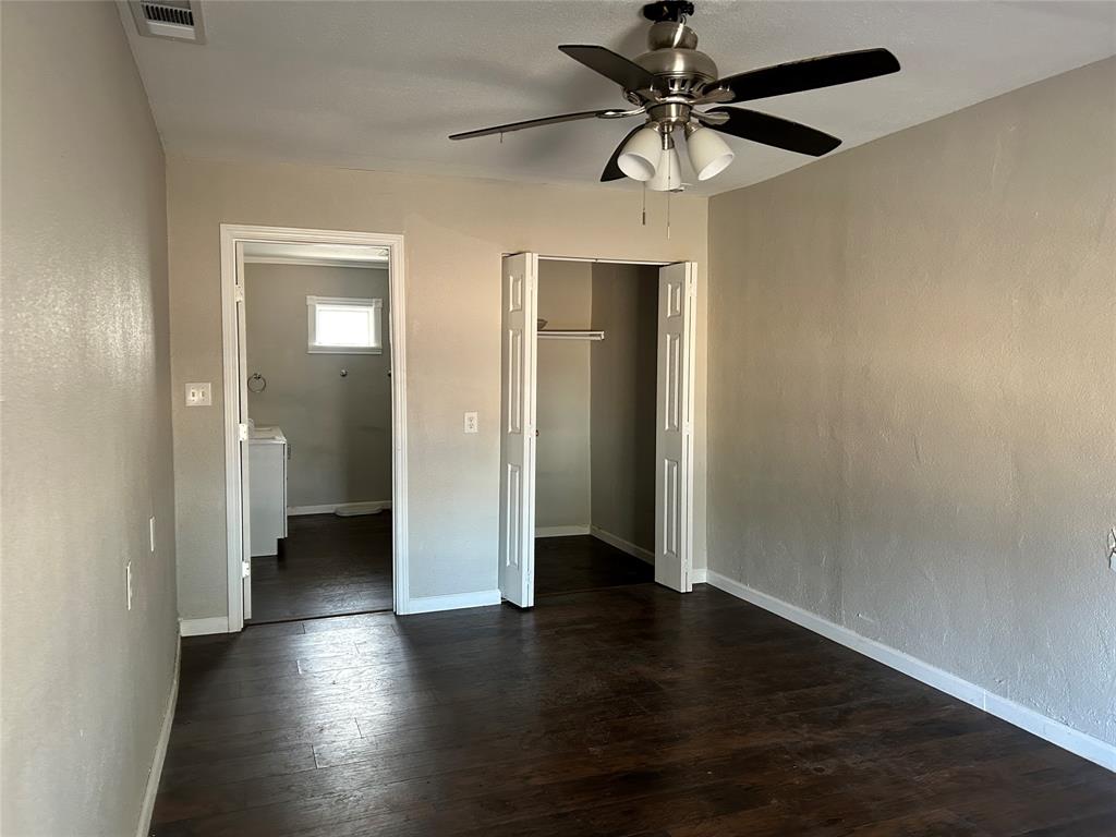 103 East Cayuga Drive Athens, TX 75751 - Photo 6 of 11 an empty room with wooden floor and a ceiling fan