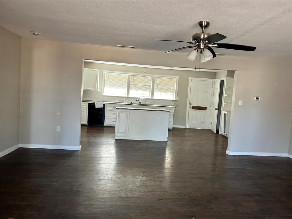103 East Cayuga Drive Athens, TX 75751 - Photo 8 of 11 a view of a kitchen with a sink dishwasher oven window and wooden floor