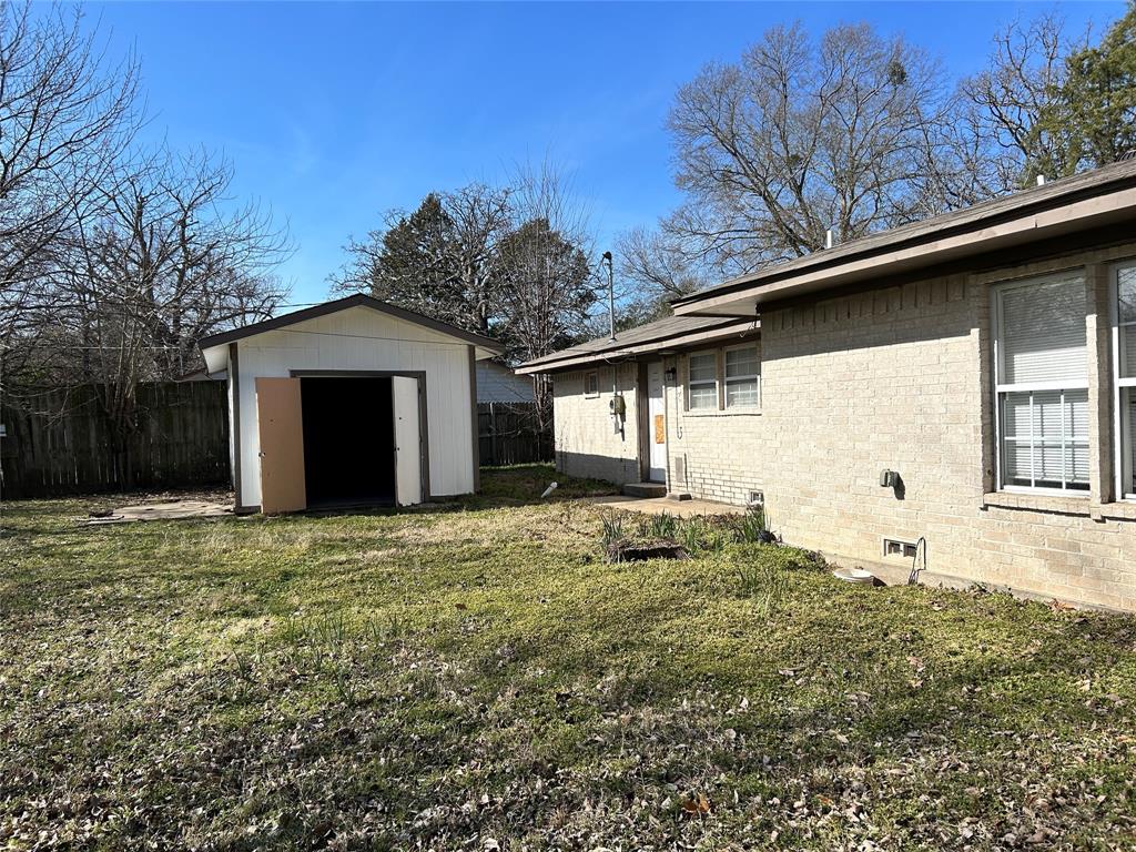 103 East Cayuga Drive Athens, TX 75751 - Photo 9 of 11 a house with trees in the background