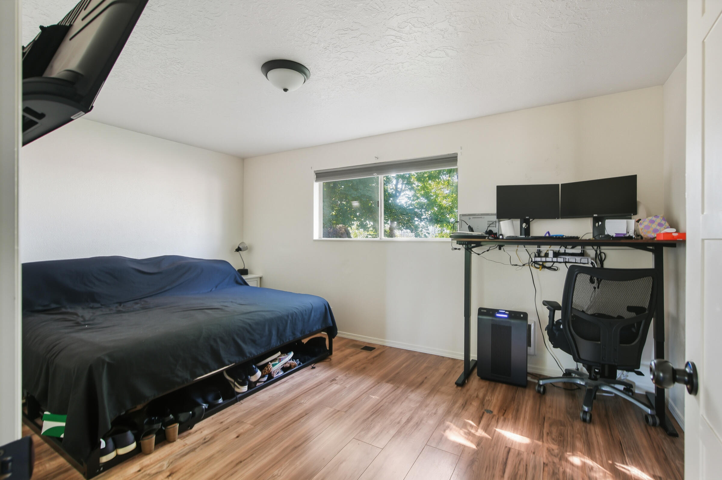 664 Southwest 35th Street Redmond, OR 97756 - Photo 11 of 19 a bedroom with a bed and a flat tv screen on the dresser