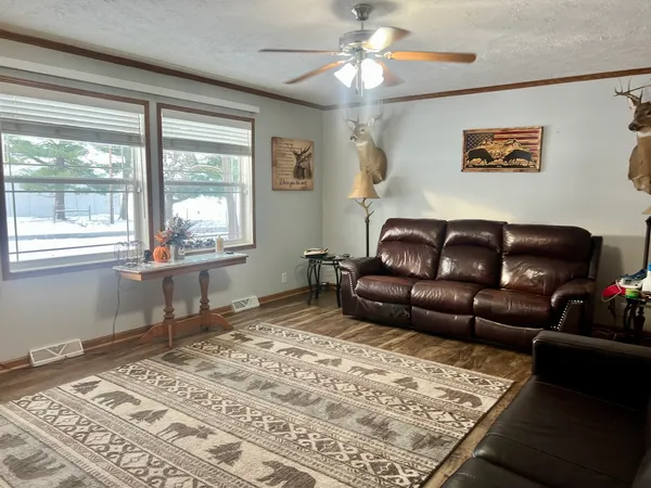 a living room with furniture or couch and two windows