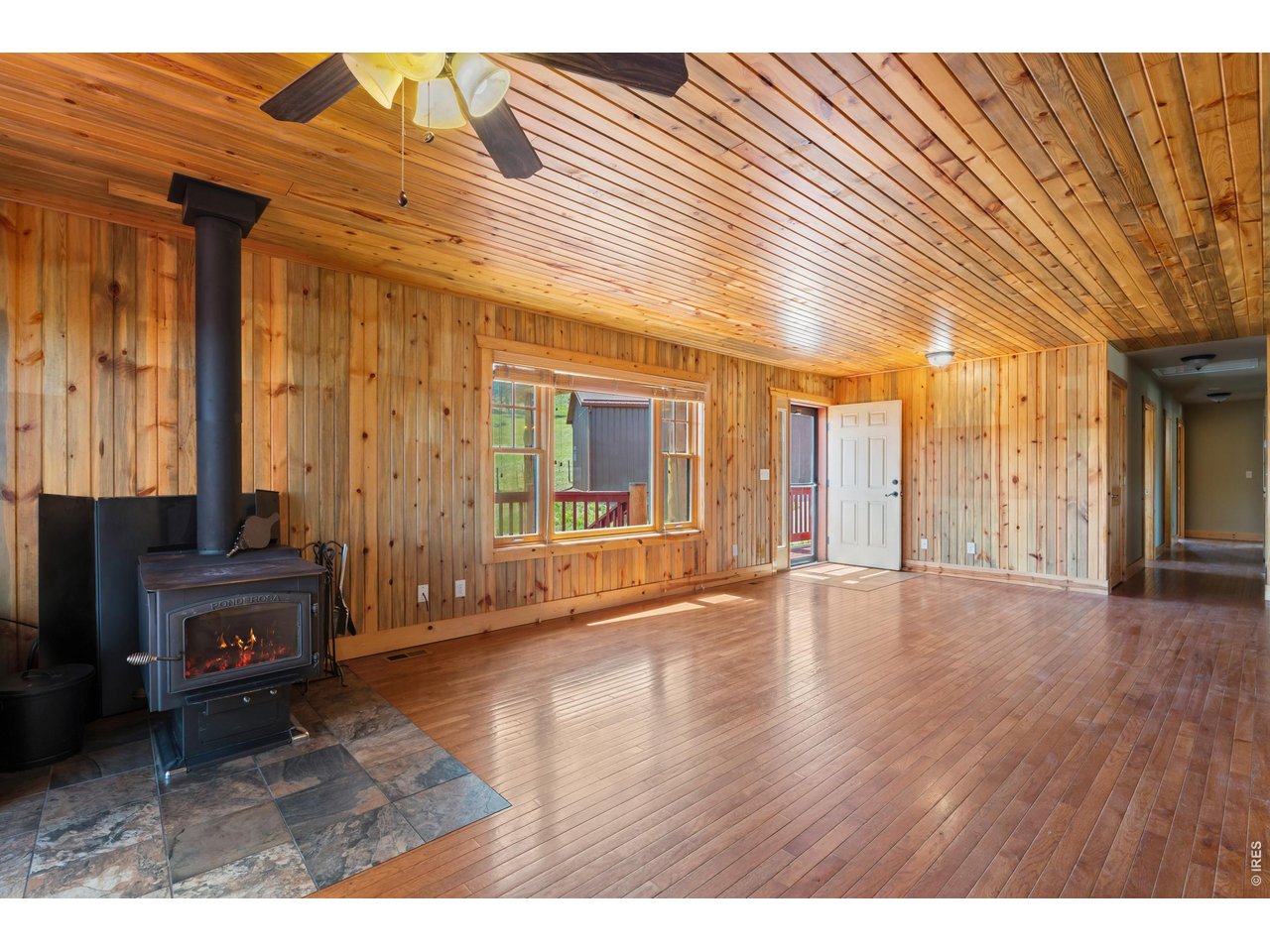 Beautiful beetle-kill pine wood interior and cozy wood stove!