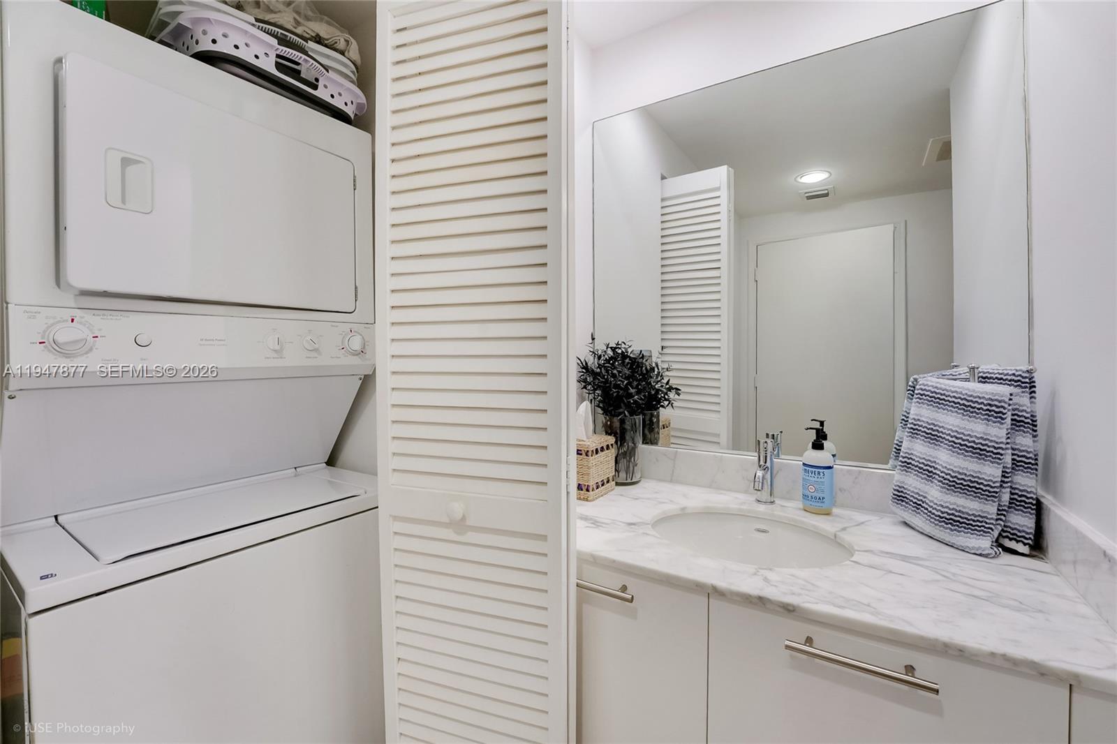 951 Brickell Avenue, Unit 1110 Miami, FL 33131 - Photo 11 of 28 a bathroom with a sink and a mirror