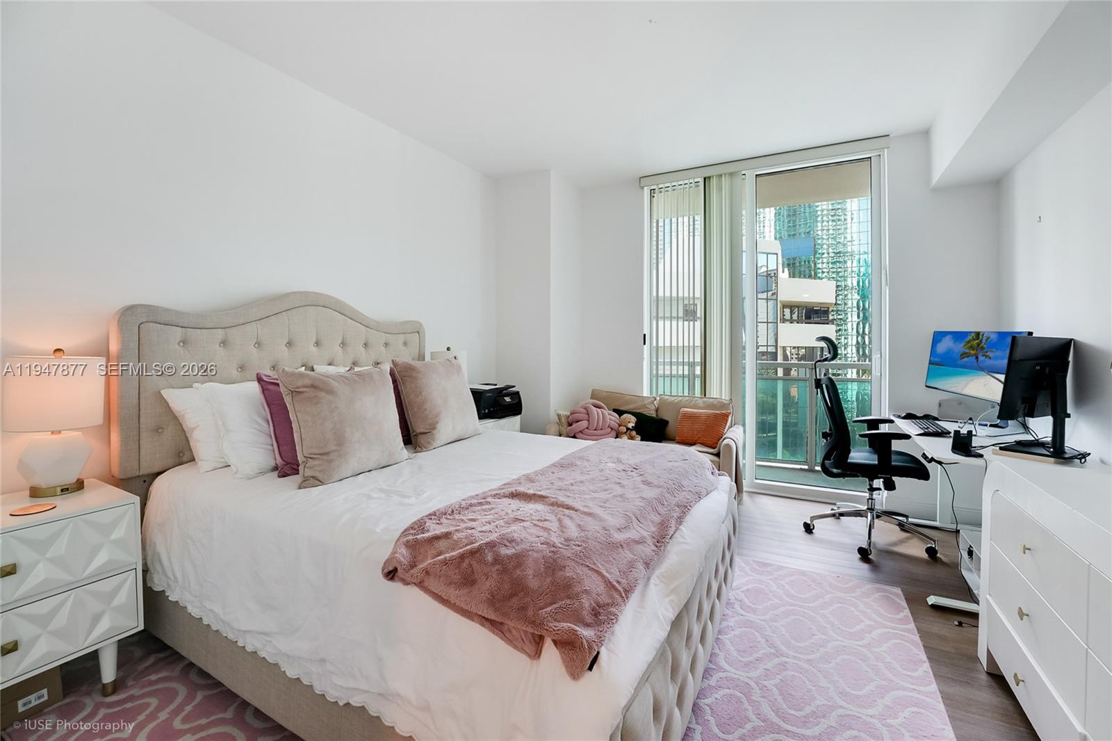 951 Brickell Avenue, Unit 1110 Miami, FL 33131 - Photo 17 of 28 a bedroom with a bed and a flat screen tv