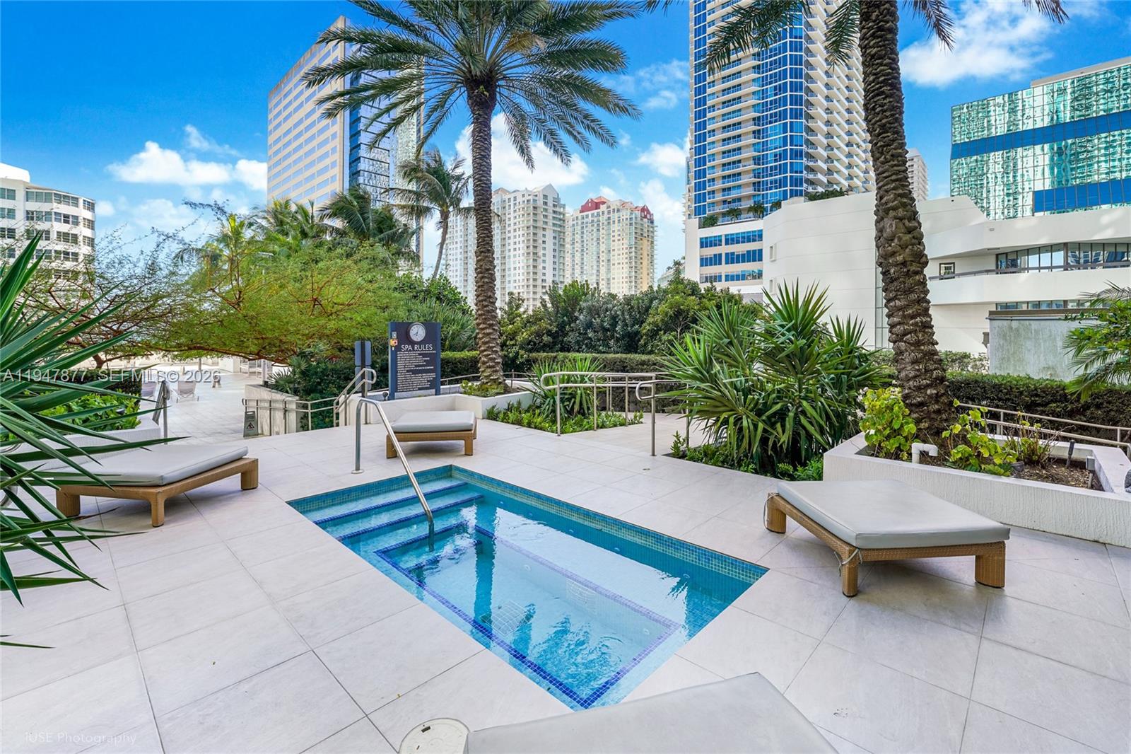 951 Brickell Avenue, Unit 1110 Miami, FL 33131 - Photo 27 of 28 a swimming pool with outdoor seating and plants