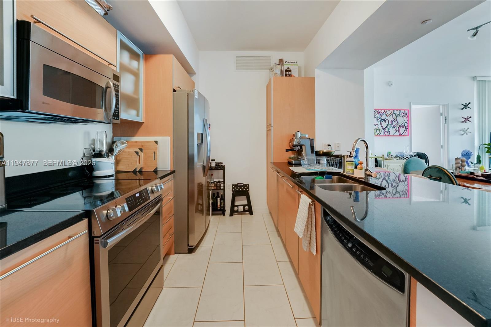 951 Brickell Avenue, Unit 1110 Miami, FL 33131 - Photo 4 of 28 a kitchen with stainless steel appliances a sink dishwasher stove and oven