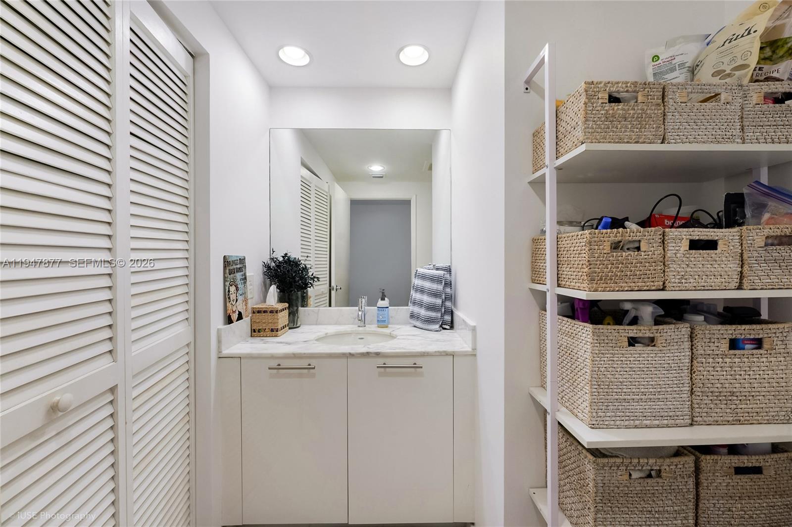 951 Brickell Avenue, Unit 1110 Miami, FL 33131 - Photo 5 of 28 a bathroom with a sink and a mirror