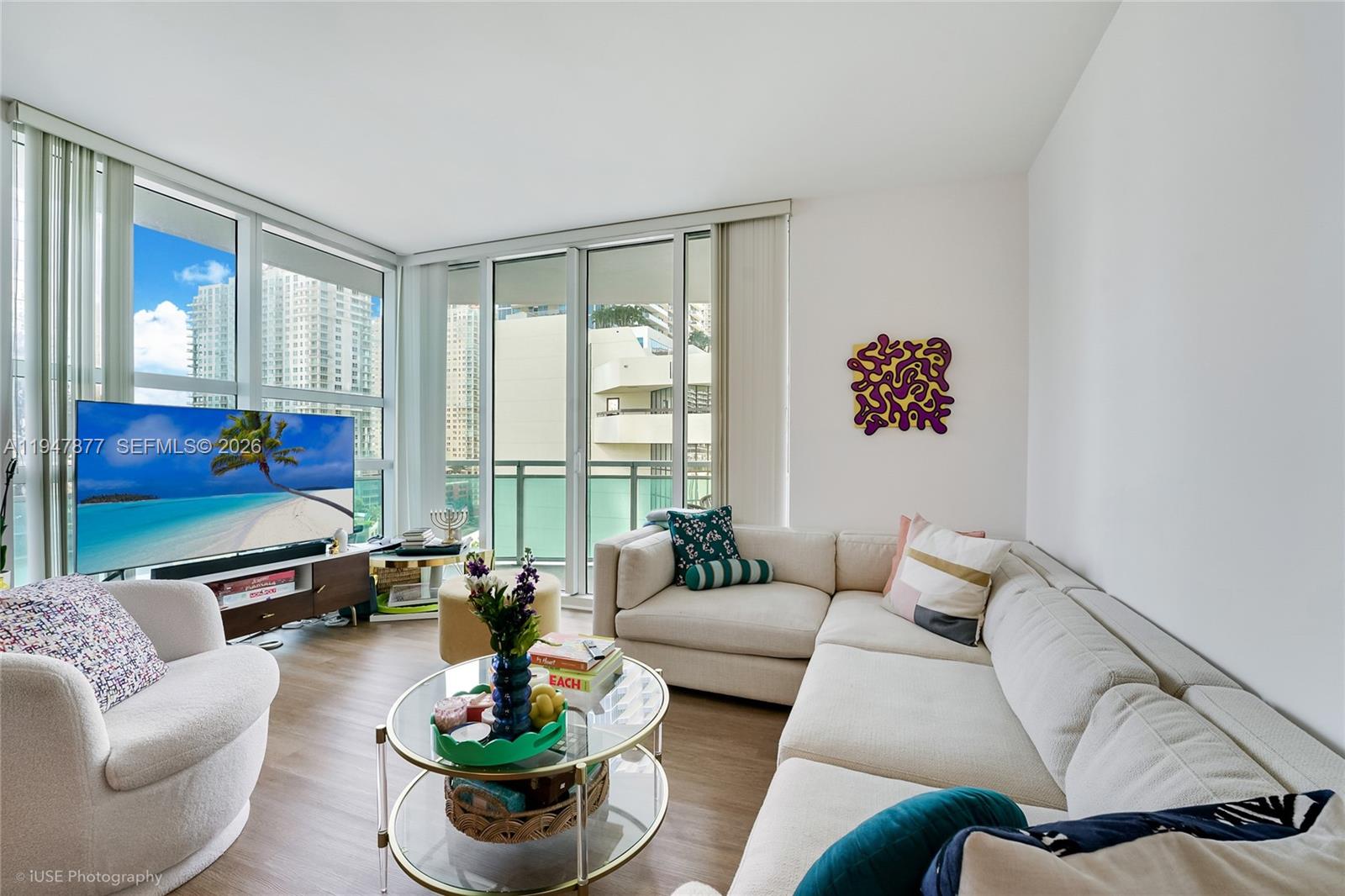 951 Brickell Avenue, Unit 1110 Miami, FL 33131 - Photo 9 of 28 a living room with furniture and a floor to ceiling window