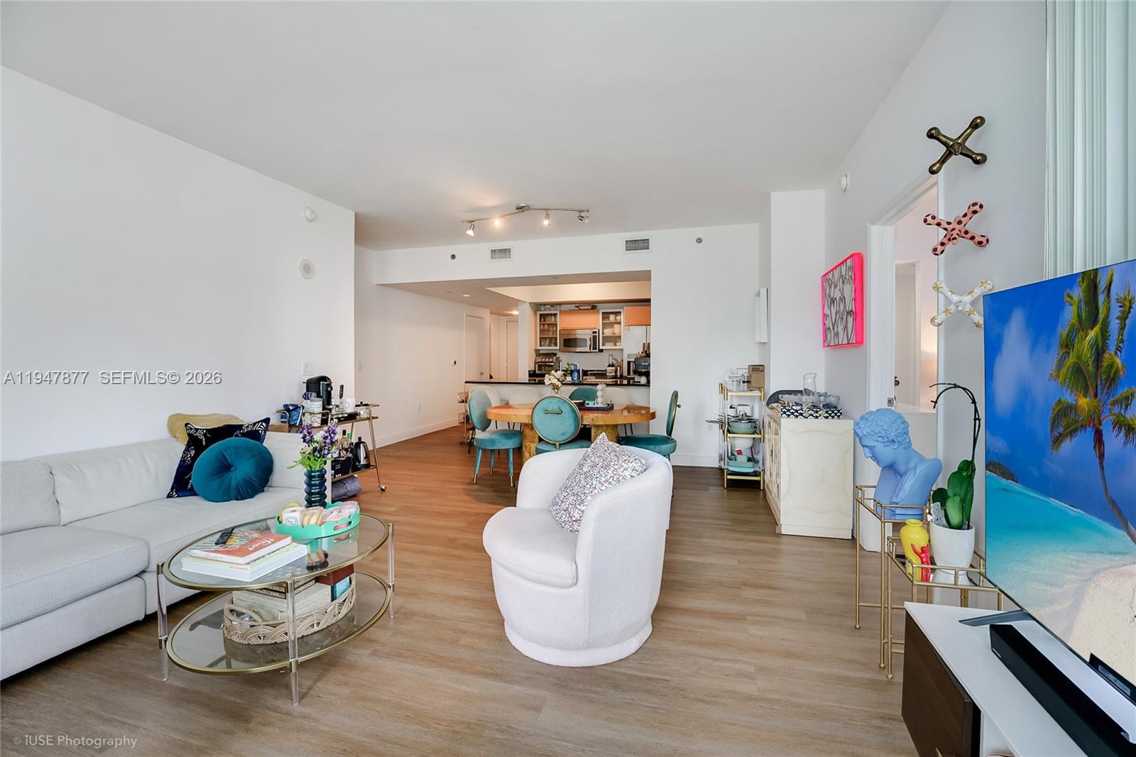 951 Brickell Avenue, Unit 1110 Miami, FL 33131 - Photo 10 of 28 a living room with furniture and a flat screen tv