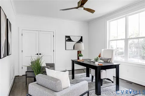 a living room with furniture and a potted plant