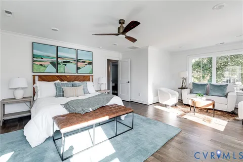 a bedroom with a bed couch and window