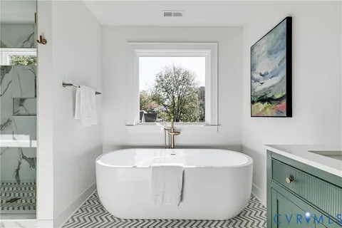 a white bath tub sitting next to a window