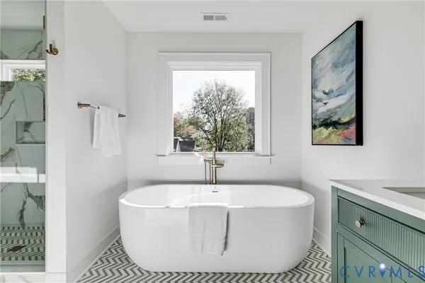 a white bath tub sitting next to a window