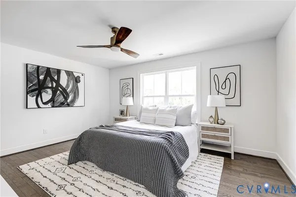 a bedroom with a bed and a painting on the wall