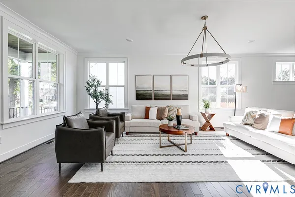 a living room with furniture a rug a lamp and a window