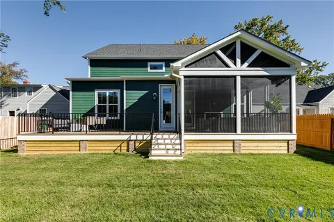 a view of a house with a yard and sitting area