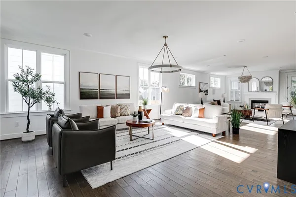 a living room with furniture fireplace and a potted plant