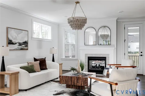 a living room with furniture a fireplace and window