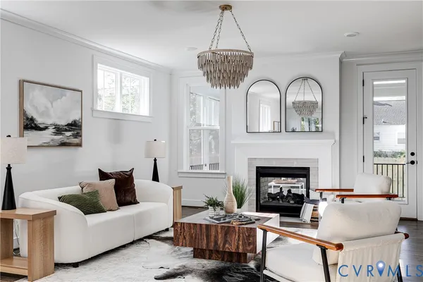 a living room with furniture a fireplace and window