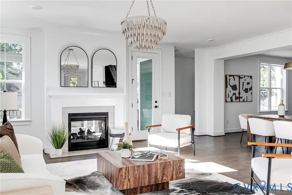 a living room with furniture a fireplace and window
