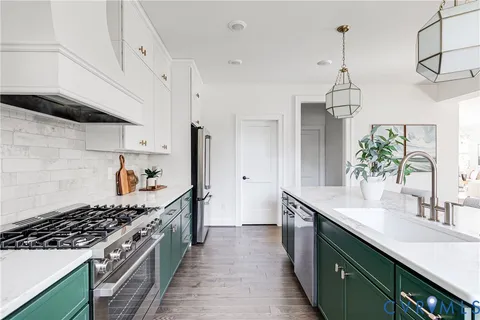 a kitchen with stainless steel appliances a sink stove and cabinets