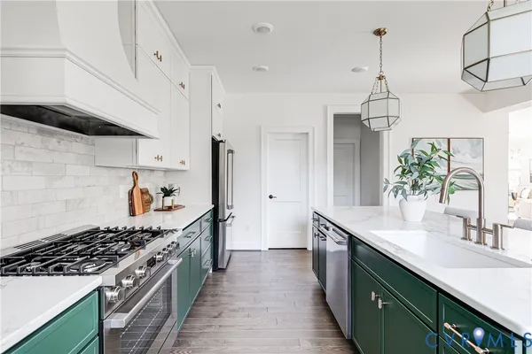 a kitchen with stainless steel appliances a sink stove and cabinets