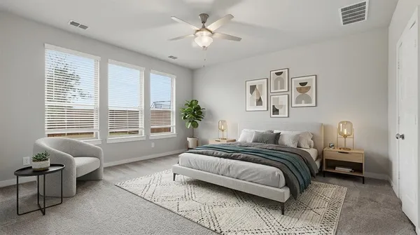 a spacious bedroom with a bed and a couch