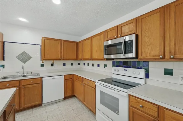 a kitchen with a sink stove and microwave
