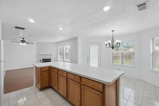 an aerial view of a house with a garden and lake view