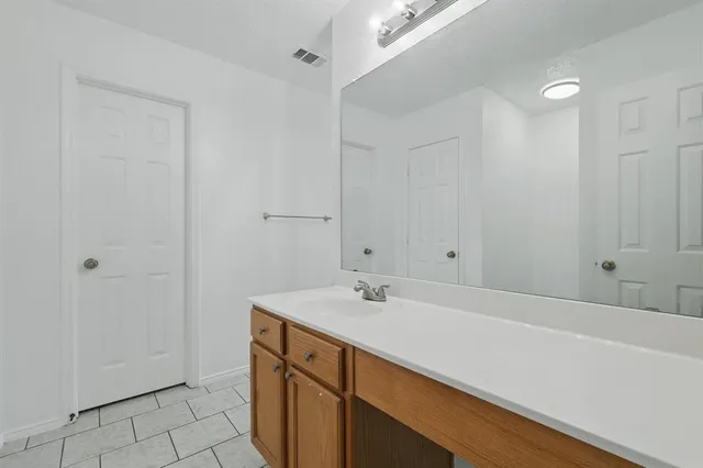 a bathroom with a sink a vanity and a mirror